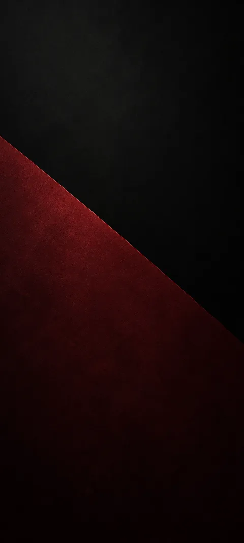 A muted burgundy plane meets charcoal darkness.