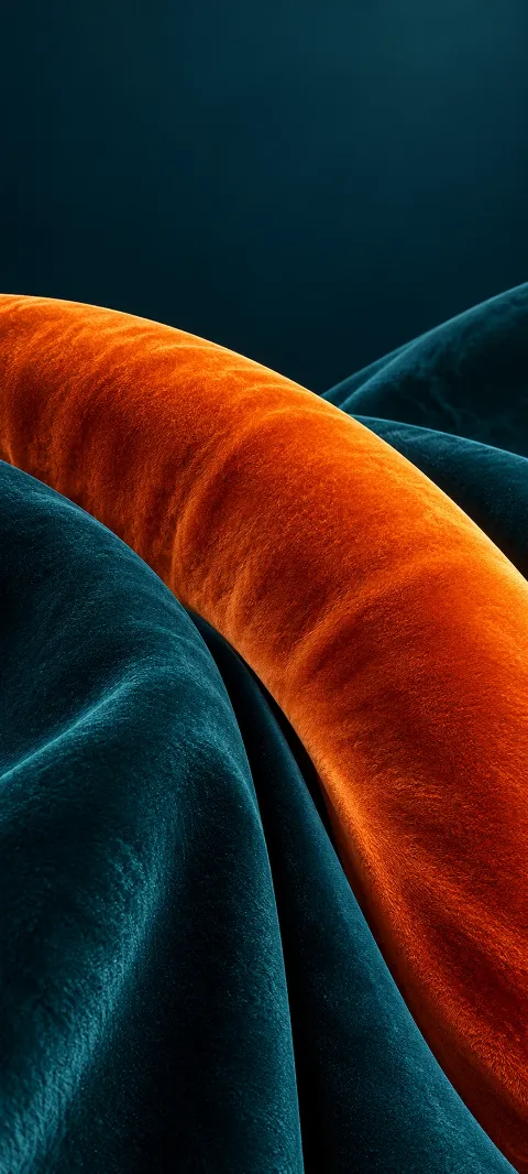 Orange velvet arc crossing plush teal folded fabric.