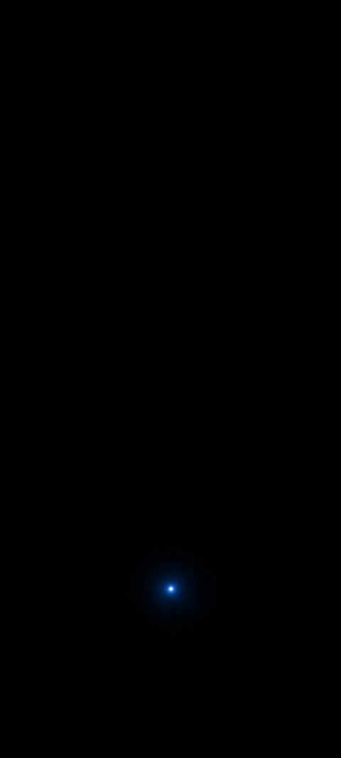 A tiny blue point glows in a broad black field.