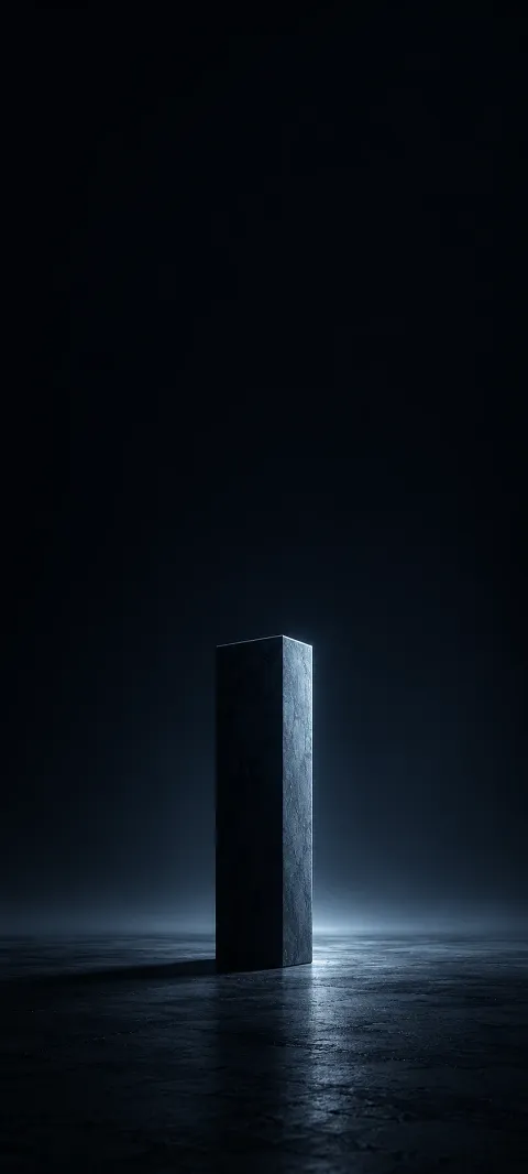 A low blue-gray pillar rises from a dark floor.