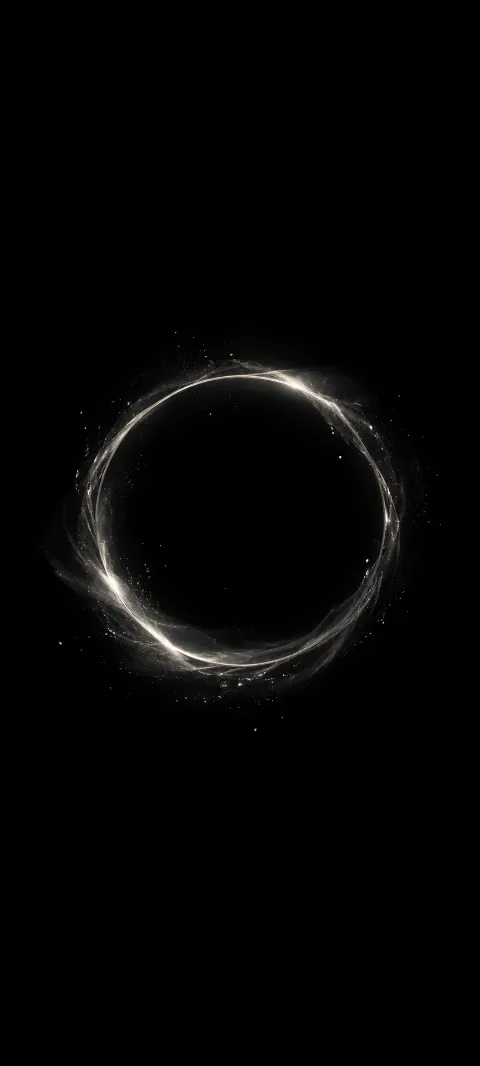 A dim silver halo floats in a black field.