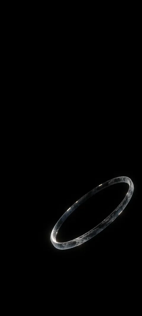 Tilted translucent glass ring against an empty black background.