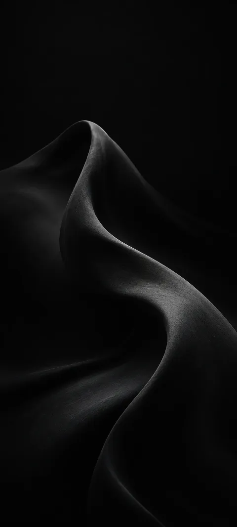 A soft charcoal fold rises from a black background.