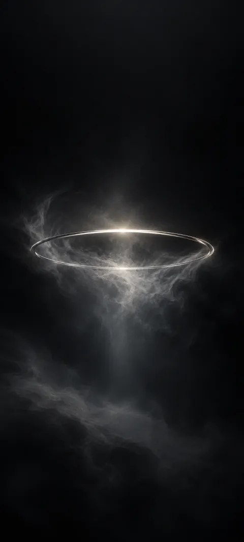 A dim silver halo floats in a black field.