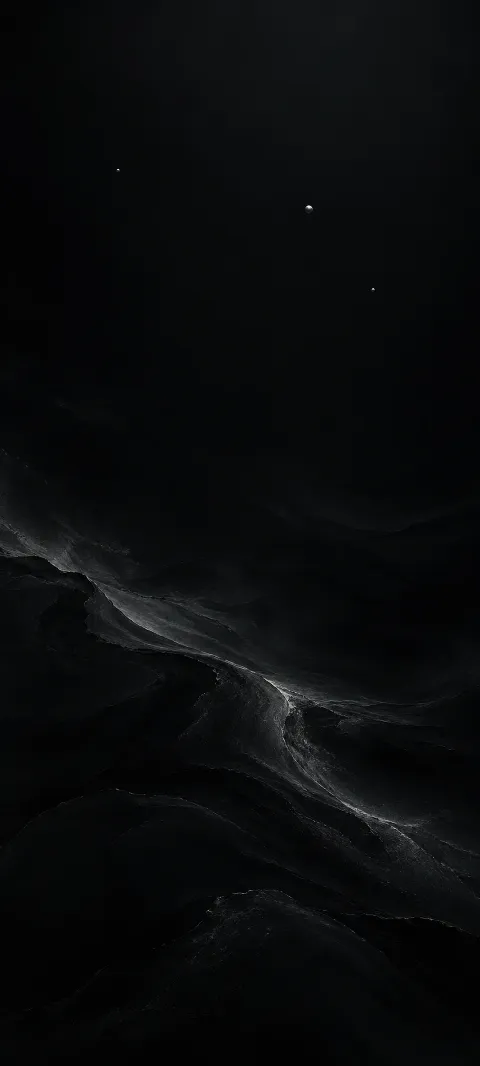 Three tiny silver specks punctuate a deep black field.