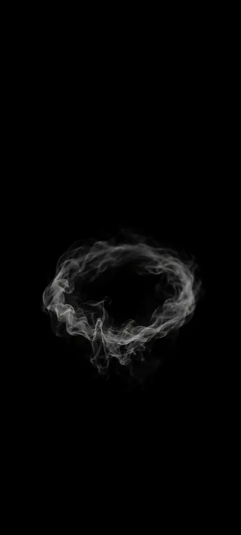 Small gray smoke ring with wispy edges against solid black.