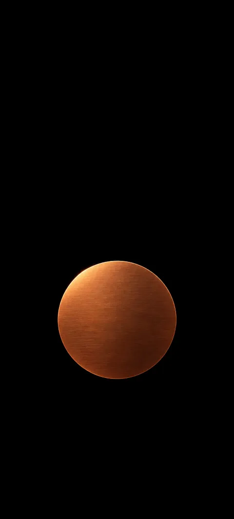 A flat copper disc sits below center on matte black.