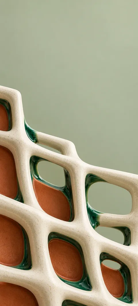 Cream ceramic lattice with emerald glazed corners above terracotta panels.