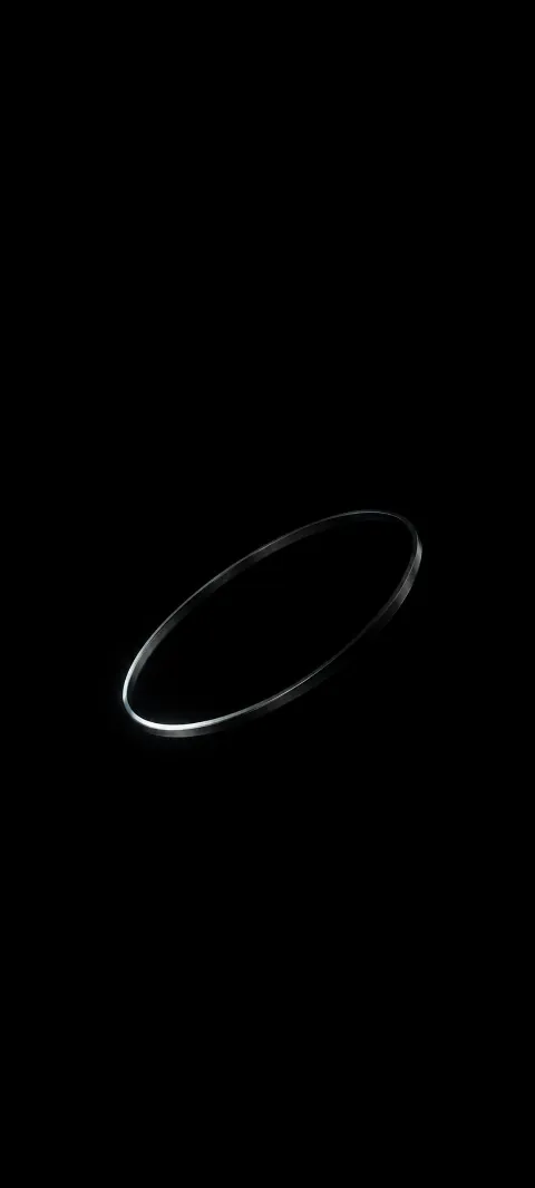 Thin tilted silver ring with a bright lower left rim against a black background.
