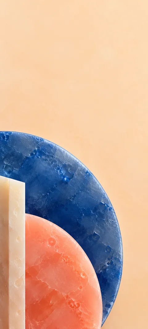 Cobalt and coral wax semicircles beside an ivory bar on apricot.