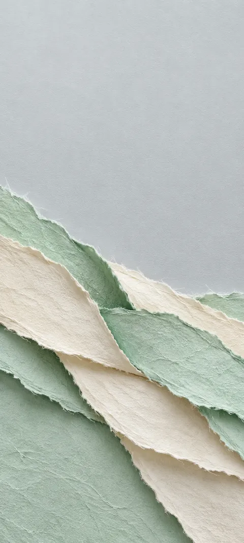 Mint and ivory handmade paper strips with torn fiber edges.