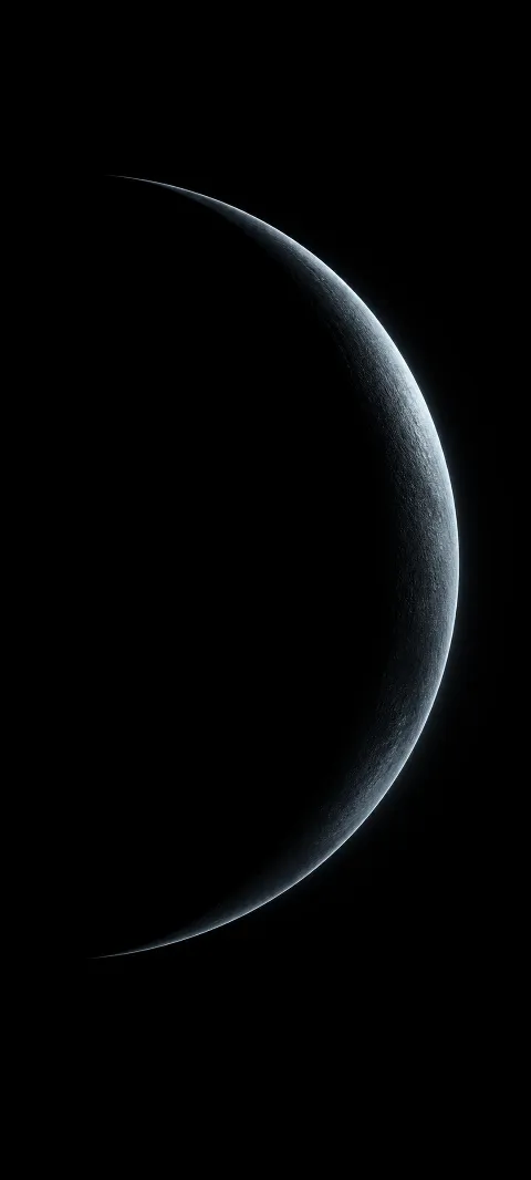 A graphite crescent catches a cool rim light.