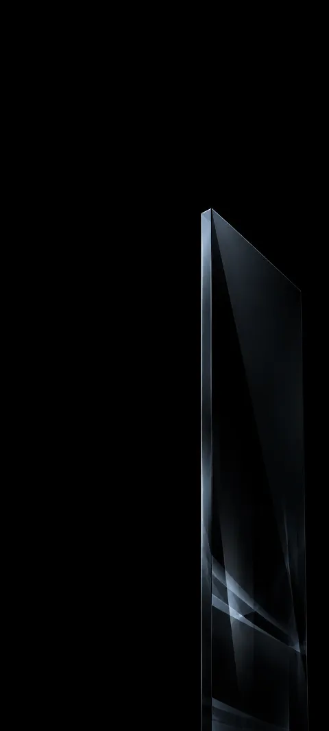 Tall black smoked-glass slab with a thin silver edge and faint angular lower reflections.