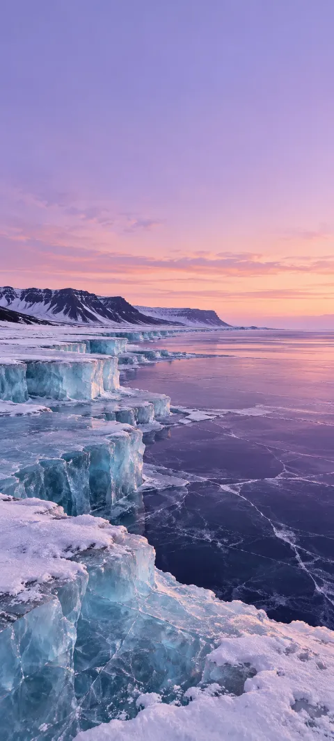 Pale blue ice shelves beside a violet frozen lake under lilac twilight.