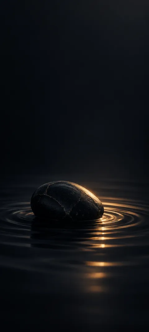 A black stone form catches one narrow highlight.