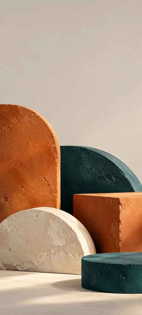 Orange, teal and cream plaster slabs and curved solids with rough texture.