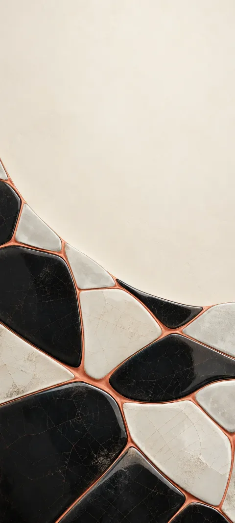 Black and pearl cracked ceramic tiles joined by coral seams on ivory.