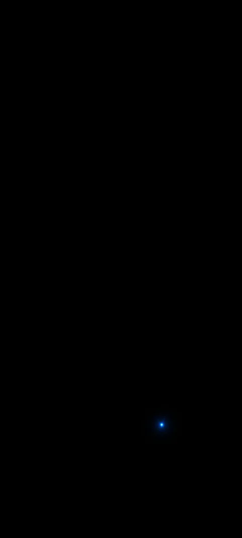 A tiny blue point glows in a broad black field.