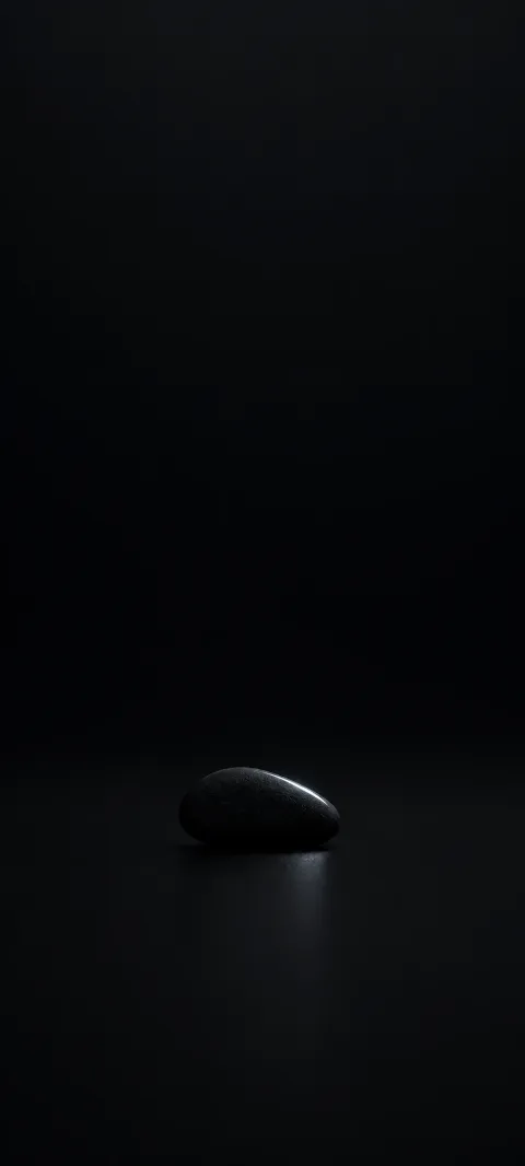 A black stone form catches one narrow highlight.