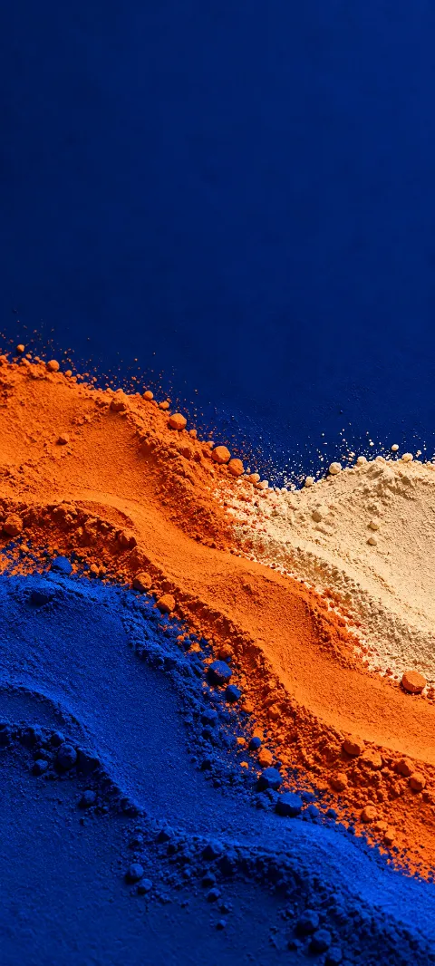 Ultramarine and burnt-orange pigment powder with pale buff ridges.