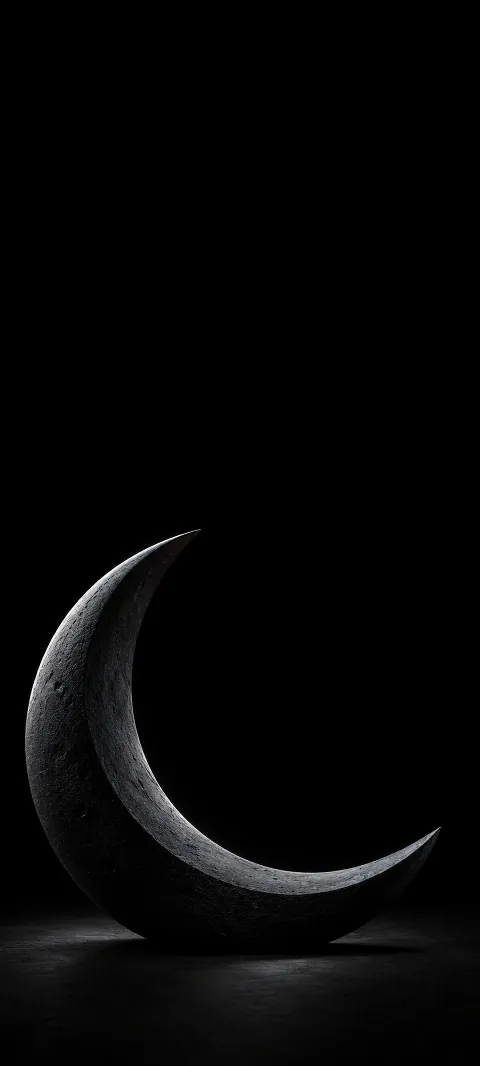 Dark graphite crescent sculpture with cool rim light on a black floor.