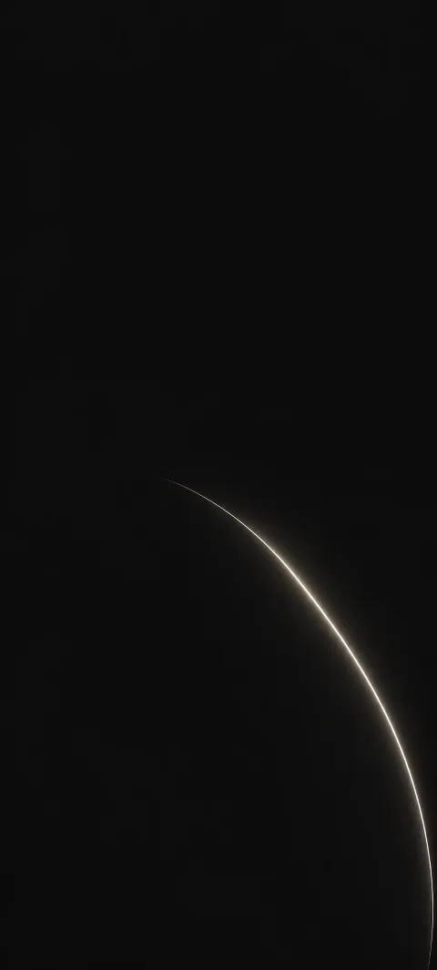 A restrained white arc emerges from graphite darkness.