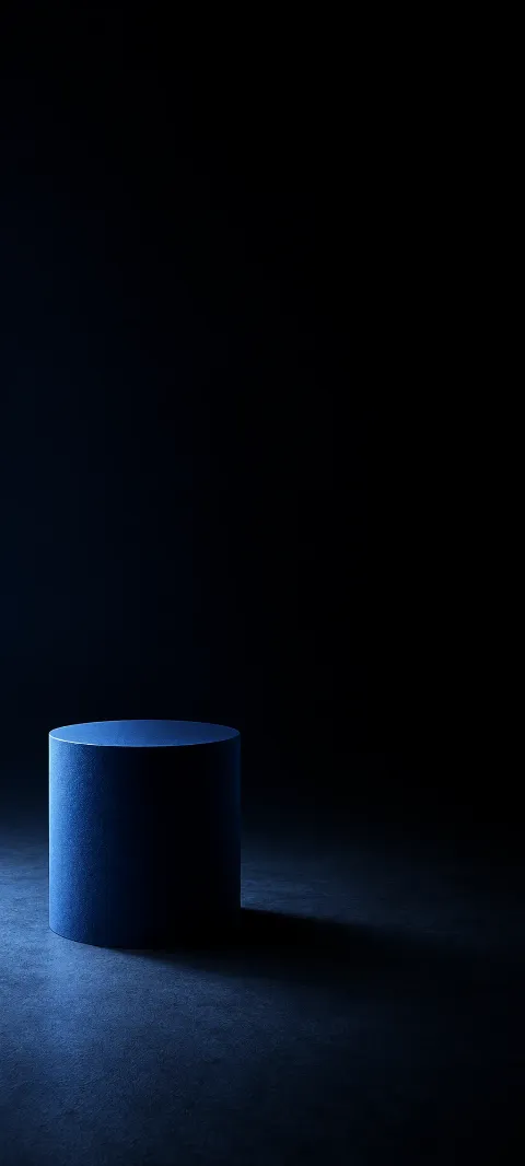 Blue cylinder on a dark charcoal surface with rim light and a soft shadow.