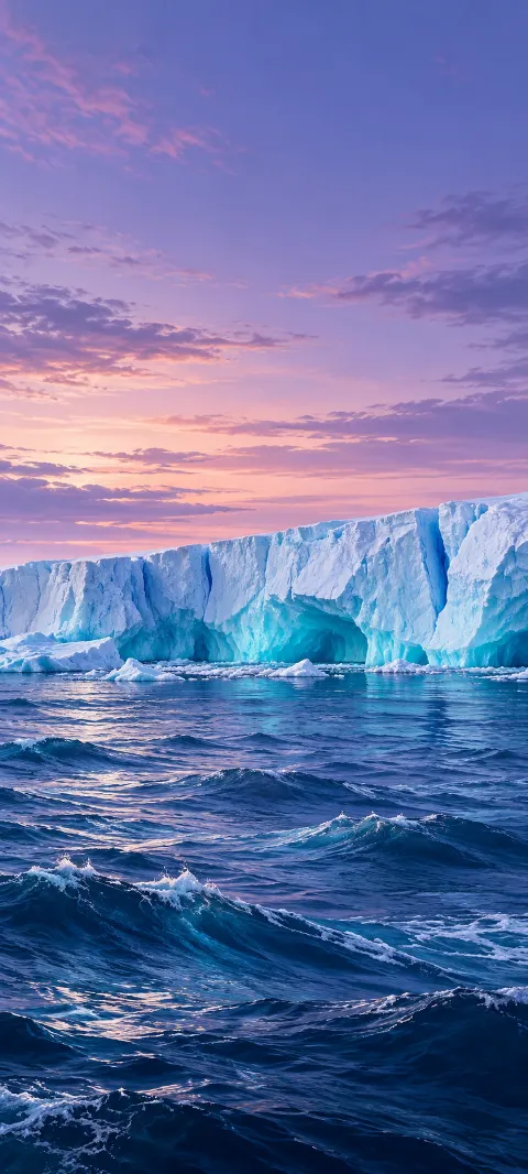 Cobalt waves beneath a pale blue ice shelf and lavender twilight sky.