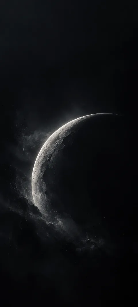 A graphite crescent catches a cool rim light.