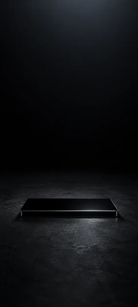 Small black glass slab with a silver edge highlight on charcoal stone.
