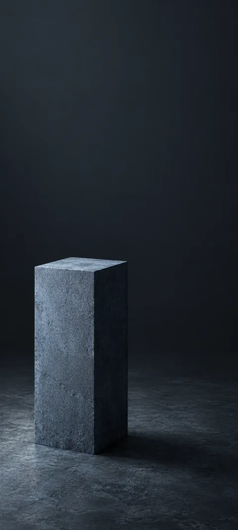 A blue-gray rectangular stone pillar on a dark floor with a soft side shadow.