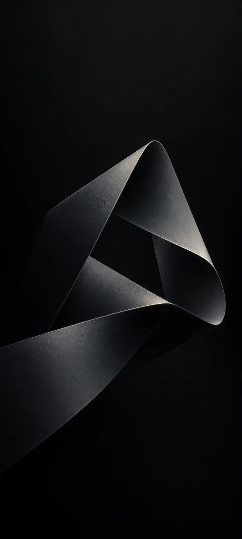 A matte graphite ribbon forms a quiet loop on black.