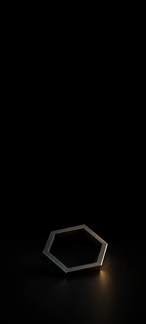 A small angled charcoal hexagonal frame on a black surface.