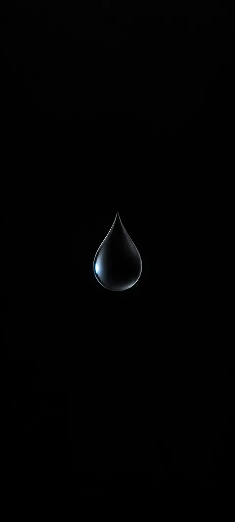 A dark droplet catches a tiny cool reflection.