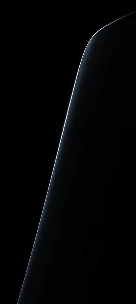 A cool highlight traces the edge of black glass.