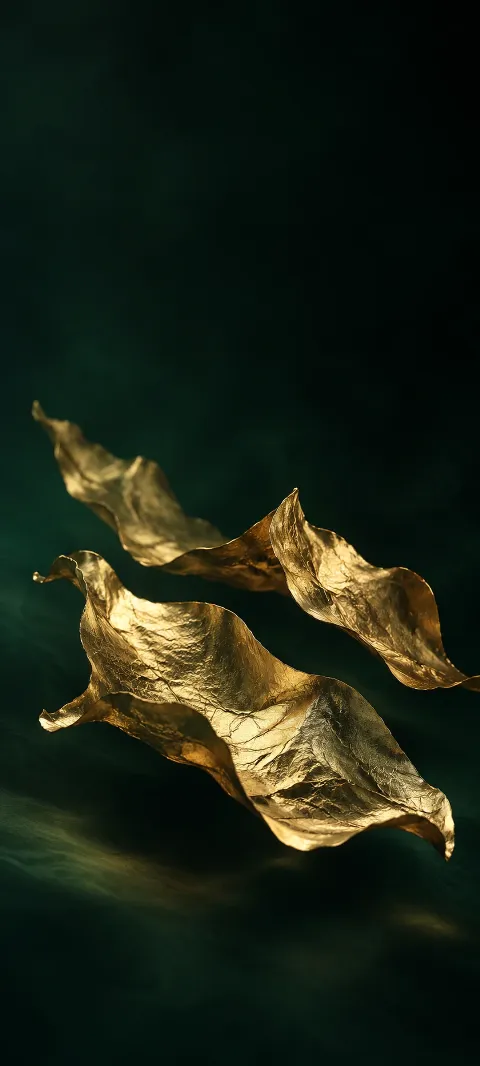 Three folded gold leaf sheets floating over a dark green-black field.