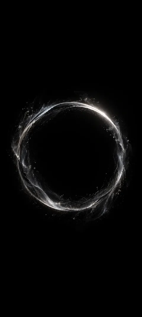 A silver ring with faint particles on a black background.