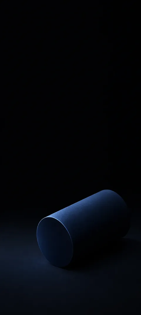 A matte midnight-blue cylinder lying diagonally in a black composition.